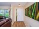 Warm foyer with wood flooring, bamboo art piece, and view into the living area, creating a welcoming entry at 10641 Timber Ln, Port Richey, FL 34668