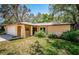 Inviting home exterior with a well-maintained lawn and mature trees providing shade and curb appeal at 10641 Timber Ln, Port Richey, FL 34668