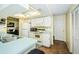 Bright kitchen features white appliances, countertops, and ample cabinet space at 10641 Timber Ln, Port Richey, FL 34668