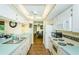 Bright kitchen features white appliances, countertops, and ample cabinet space at 10641 Timber Ln, Port Richey, FL 34668