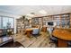 Resident library featuring cozy seating and extensive bookshelves with books and a TV for community enjoyment at 10641 Timber Ln, Port Richey, FL 34668