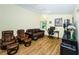 Bright living room with vaulted ceilings, skylight, and comfortable leather seating, perfect for relaxation and entertainment at 10641 Timber Ln, Port Richey, FL 34668