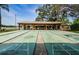 Outdoor shuffleboard courts with covered seating overlooking the lake at 10641 Timber Ln, Port Richey, FL 34668