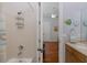 Cozy bathroom featuring a shower, beige vanity, and nautical decorations at 10701 Ruffino Ct, Trinity, FL 34655