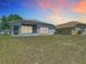 Spacious backyard featuring a screened lanai, perfect for outdoor enjoyment and evening relaxation at 1082 Nodding Shade Dr, Brooksville, FL 34604