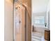 Well-lit bathroom with a glass-enclosed shower and large soaking tub next to a bright window at 1082 Nodding Shade Dr, Brooksville, FL 34604
