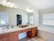 Elegant bathroom with a dual vanity, window and bathtub at 1082 Nodding Shade Dr, Brooksville, FL 34604