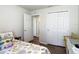 Comfortable bedroom with a closet, open door and wood-look floors at 1082 Nodding Shade Dr, Brooksville, FL 34604