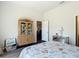 Bright bedroom featuring a curio cabinet, seahorse decor and ensuite bath access at 1082 Nodding Shade Dr, Brooksville, FL 34604