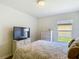 Bedroom featuring a wicker dresser and a view to the exterior of the home at 1082 Nodding Shade Dr, Brooksville, FL 34604