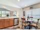 View of dining area showing wooden table, chairs, stainless dishwasher, and modern flooring at 1082 Nodding Shade Dr, Brooksville, FL 34604