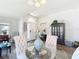 Bright dining area featuring a glass table, upholstered chairs, and stylish decor in an open floor plan at 1082 Nodding Shade Dr, Brooksville, FL 34604