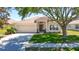 Charming single-story home features a well-maintained lawn, two-car garage, and inviting front entrance at 1082 Nodding Shade Dr, Brooksville, FL 34604