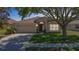 Charming single-story home features a well-maintained lawn, two-car garage, and inviting front entrance at 1082 Nodding Shade Dr, Brooksville, FL 34604