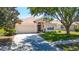 Charming single-story home features a well-maintained lawn, two-car garage, and inviting front entrance at 1082 Nodding Shade Dr, Brooksville, FL 34604