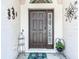 Inviting front entrance with a decorative door, charming decorations, and a welcoming mat at 1082 Nodding Shade Dr, Brooksville, FL 34604