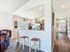 Open-concept kitchen with breakfast bar and views into the living and dining areas at 1082 Nodding Shade Dr, Brooksville, FL 34604