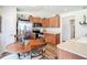 Kitchen and eating area with stainless steel refrigerator and wooden cabinets at 1082 Nodding Shade Dr, Brooksville, FL 34604