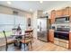 Kitchen features wood cabinets, stainless steel appliances, and breakfast nook at 1082 Nodding Shade Dr, Brooksville, FL 34604