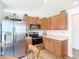 Kitchen shows stainless steel refrigerator, oven, and wooden cabinets at 1082 Nodding Shade Dr, Brooksville, FL 34604