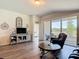 Cozy living room with hardwood floors and sliding glass doors that lead to the lanai at 1082 Nodding Shade Dr, Brooksville, FL 34604
