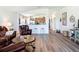 Open-concept living room area view to the kitchen with breakfast bar and hardwood floors at 1082 Nodding Shade Dr, Brooksville, FL 34604