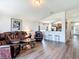 Spacious living room featuring leather seating and open access to the breakfast bar at 1082 Nodding Shade Dr, Brooksville, FL 34604