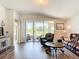 Bright living room with hardwood floors, leather seating and sliding glass doors to the outside at 1082 Nodding Shade Dr, Brooksville, FL 34604
