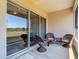 Cozy patio features comfortable wicker chairs and a view of the outdoor landscape at 1082 Nodding Shade Dr, Brooksville, FL 34604