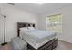 Bright bedroom featuring a comfortable bed with storage and a sunny window at 11310 Limpkin Rd, Weeki Wachee, FL 34614