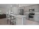Well-appointed kitchen featuring stainless steel appliances, ample counter space, and seating at the island at 11310 Limpkin Rd, Weeki Wachee, FL 34614