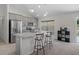 Modern kitchen with stainless steel appliances, gray cabinetry, and an island with bar stool seating at 11310 Limpkin Rd, Weeki Wachee, FL 34614