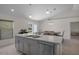 Modern kitchen island featuring a stainless steel sink and dishwasher, complemented by granite countertops at 11310 Limpkin Rd, Weeki Wachee, FL 34614