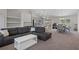 Open-concept living room with modern furniture, seamlessly blending into the kitchen and dining area at 11310 Limpkin Rd, Weeki Wachee, FL 34614
