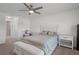 Airy main bedroom featuring a ceiling fan and white furniture set at 11310 Limpkin Rd, Weeki Wachee, FL 34614