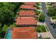 This aerial view showcases a well-maintained neighborhood with red-tiled roofs and lush landscaping at 1171 Dartford Dr, Tarpon Springs, FL 34688