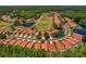 Aerial view of beautiful community homes with golf course, lake, and lush trees at 1171 Dartford Dr, Tarpon Springs, FL 34688