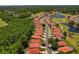 Aerial view of neighborhood homes with lush trees, a lake, and manicured lawns at 1171 Dartford Dr, Tarpon Springs, FL 34688