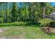 The lush and private backyard offers a serene escape with mature trees and vibrant greenery, perfect for relaxation at 1171 Dartford Dr, Tarpon Springs, FL 34688