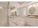 Bright bathroom features soaking tub, glass shower, and double sink vanity at 1171 Dartford Dr, Tarpon Springs, FL 34688