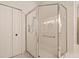 Modern bathroom features a glass shower with door, neutral tile, and white vanity at 1171 Dartford Dr, Tarpon Springs, FL 34688