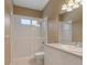 Bright bathroom featuring a shower with glass doors, vanity with sink, and neutral color palette at 1171 Dartford Dr, Tarpon Springs, FL 34688