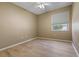 Bedroom with neutral walls, ceiling fan, and natural light from window offers a blank canvas at 1171 Dartford Dr, Tarpon Springs, FL 34688