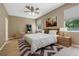 Staged bedroom featuring a large bed, modern decor, and windows at 1171 Dartford Dr, Tarpon Springs, FL 34688