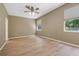 Large empty bedroom features modern floors, two windows, and a ceiling fan at 1171 Dartford Dr, Tarpon Springs, FL 34688