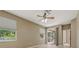 Spacious bedroom features windows, a ceiling fan, and sliding glass door access at 1171 Dartford Dr, Tarpon Springs, FL 34688