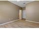 Bedroom with neutral walls, ceiling fan, and hardwood floor has closet and ensuite bath at 1171 Dartford Dr, Tarpon Springs, FL 34688
