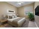 Staged bedroom boasts a comfortable bed, neutral walls, and a large window with natural light at 1171 Dartford Dr, Tarpon Springs, FL 34688