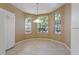 Bright breakfast nook with large windows and tile floor at 1171 Dartford Dr, Tarpon Springs, FL 34688