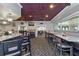 Restaurant dining room with tables, booths, patterned carpet and a coffered ceiling at 1171 Dartford Dr, Tarpon Springs, FL 34688